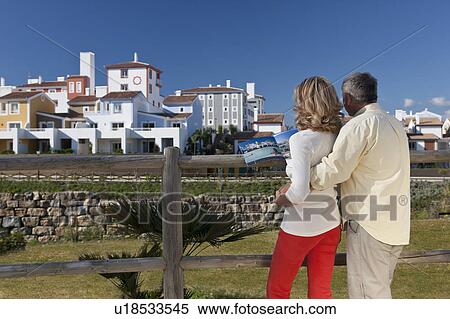 Stock Photography - Mature couple looking at development. Fotosearch