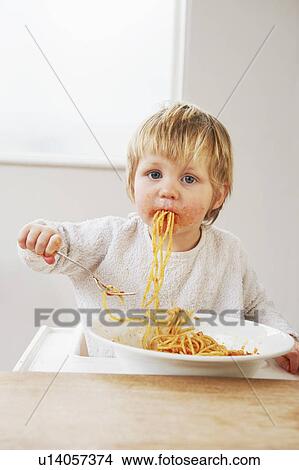 Messy baby boy eating spaghetti View Large Photo Image Picture - Messy baby boy eating spaghetti. Fotosearch