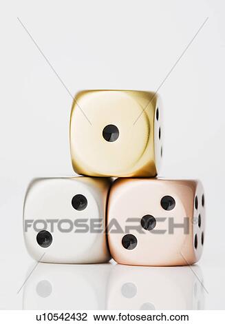 Stock Image - Metallic dices on winners podium. Fotosearch