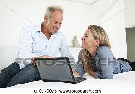 Stock Photography - Middle aged couple discuss finances. Fotosearch