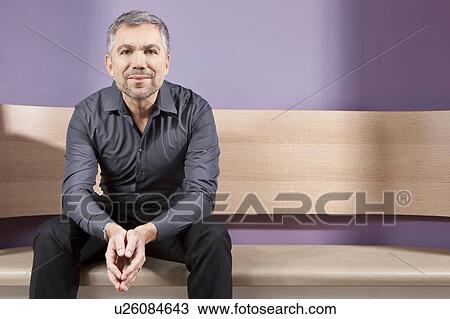 Middle aged man sitting on bench View Large Photo Image Stock Image - Middle aged man sitting on bench. Fotosearch
