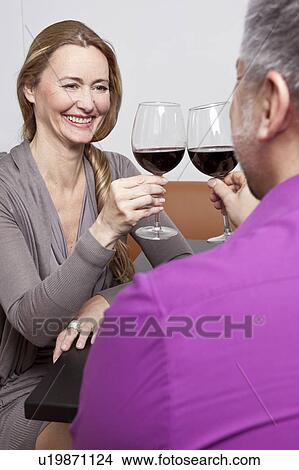 Middle aged people clinking glasses View Large Photo Image Picture - Middle aged people clinking glasses. Fotosearch