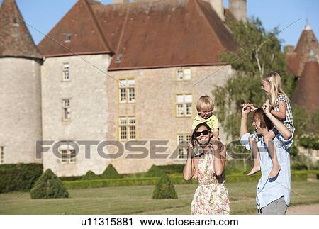Mom and dad with kids on their shoulders View Large Photo Image Stock Image - Mom and dad with kids on their shoulders. Fotosearch