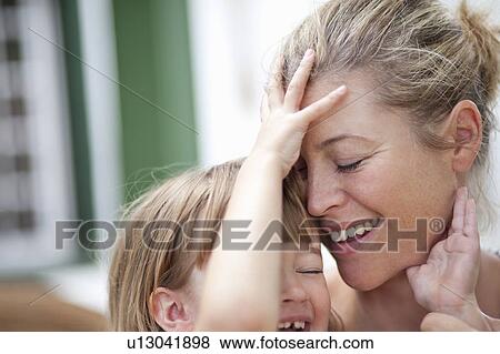 Mom hugging kid View Large Photo Image Stock Photo - Mom hugging kid. Fotosearch
