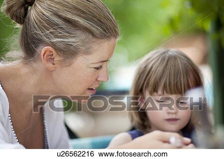 Mom teaching kid View Large Photo Image Stock Photograph - Mom teaching kid. Fotosearch