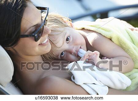 Mother and baby boy resting after pool View Large Photo Image Stock Photo - Mother and baby boy resting after pool. Fotosearch