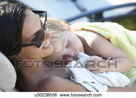 Mother and baby boy resting after pool View Large Photo Image Stock Photograph - Mother and baby boy resting after pool. Fotosearch
