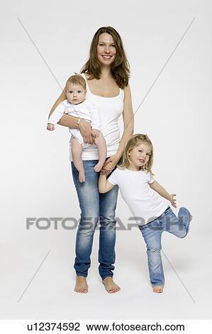 Mother and children standing together View Large Photo Image Stock Image - Mother and children standing together. Fotosearch