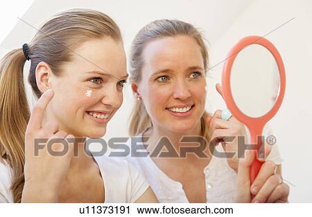 Mother and daughter applying makeup View Large Photo Image Stock Image - Mother and daughter applying makeup. Fotosearch