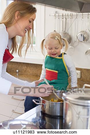 Mother and daughter cooking together View Large Photo Image Stock Image - Mother and daughter cooking together. Fotosearch