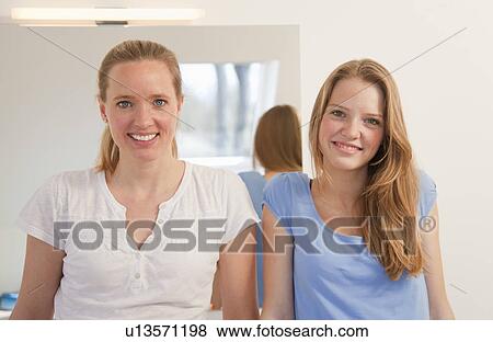 Mother and daughter smiling in bathroom View Large Photo Image Stock Photo - Mother and daughter smiling in bathroom. Fotosearch