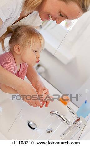 Mother and daughter washing hands View Large Photo Image Stock Image - Mother and daughter washing hands. Fotosearch