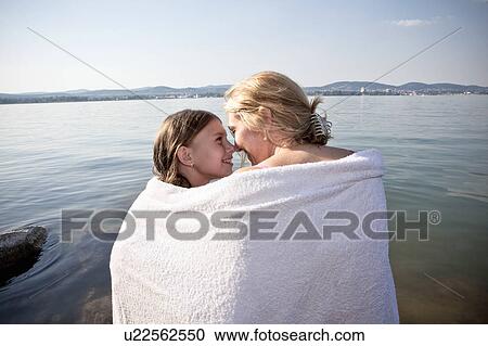 Mother and daughter wrapped in towel View Large Photo Image Stock Image - Mother and daughter wrapped in towel. Fotosearch