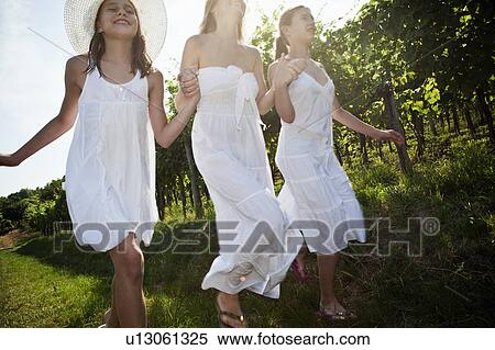 Mother and daughters running in vineyard View Large Photo Image Stock Photography - Mother and daughters running in vineyard. Fotosearch