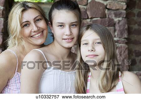 Stock Photo - Mother and daughters to camera. Fotosearch