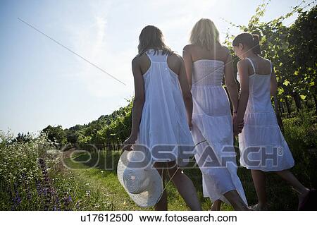 Mother and daughters walking rear view View Large Photo Image Stock Image - Mother and daughters walking rear view. Fotosearch
