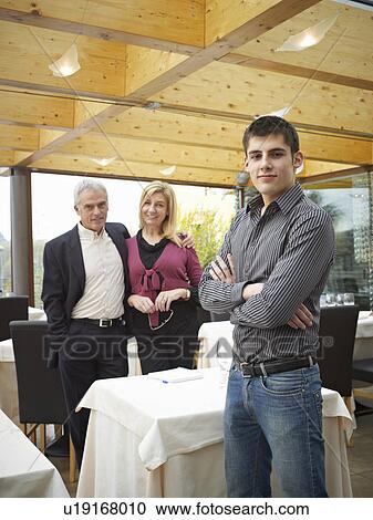 Stock Image - Mother and Father looking at their son. Handing over the family business. Fotosearch