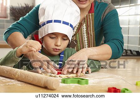 Mother and son cooking together View Large Photo Image Picture - Mother and son cooking together. Fotosearch