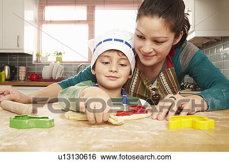 Mother and son cooking together View Large Photo Image Stock Photograph - Mother and son cooking together. Fotosearch