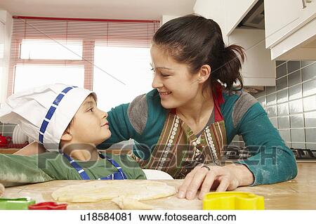 Mother and son having fun in kitchen View Large Photo Image Stock Image - Mother and son having fun in kitchen. Fotosearch