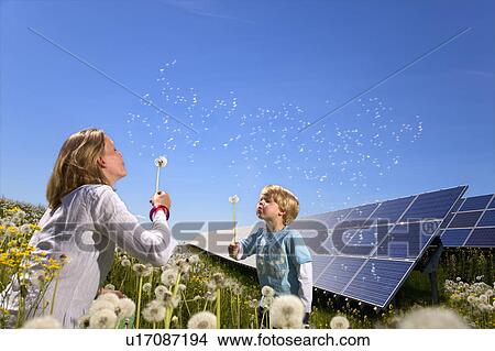 Mother and son with solar panels View Large Photo Image Picture - Mother and son with solar panels. Fotosearch