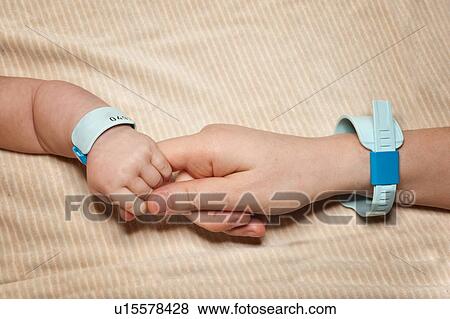 Newborn and mum with hospital bracelets View Large Photo Image Stock Photo - Newborn and mum with hospital bracelets. Fotosearch