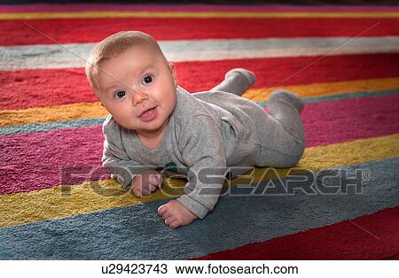 Newborn boy on the carpet View Large Photo Image Stock Image - Newborn boy on the carpet. Fotosearch