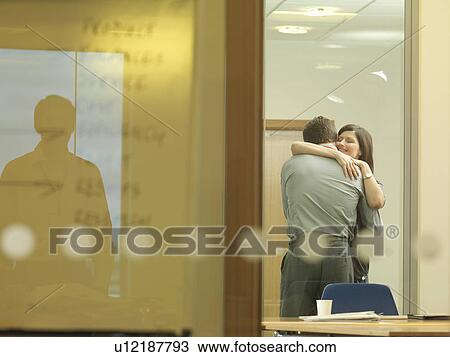 Office couple cuddling View Large Photo Image Stock Image - Office couple cuddling. Fotosearch