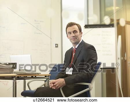 Stock Image - Office executive smiling. Fotosearch