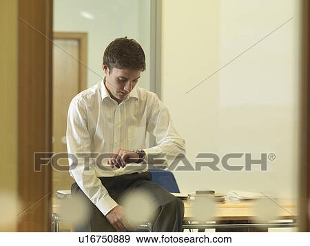 Office man looking at watch View Large Photo Image Stock Photo - Office man looking at watch. Fotosearch