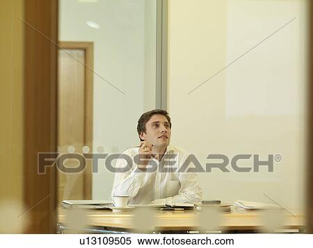 Office man sitting at desk View Large Photo Image Stock Photography - Office man sitting at desk. Fotosearch