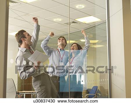 Stock Image - Office staff celebrating. Fotosearch