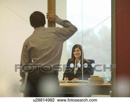 Stock Image - Office staff chatting. Fotosearch