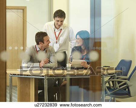 Stock Photo - Office staff in meeting. Fotosearch
