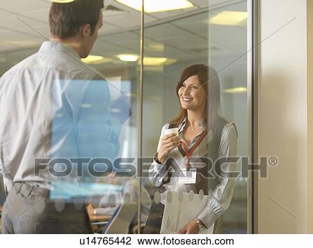 Stock Image - Office staff talking. Fotosearch