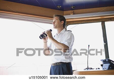 Officer holding binoculars in his hands View Large Photo Image Stock Image - Officer holding binoculars in his hands. Fotosearch