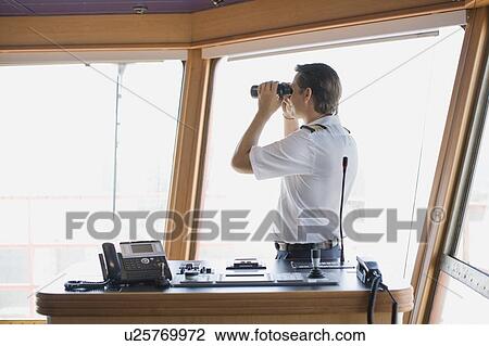 Officer looking through binoculars View Large Photo Image Stock Image - Officer looking through binoculars. Fotosearch