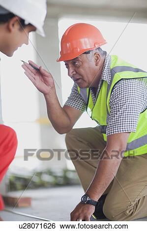 Old worker talking to young worker View Large Photo Image Stock Photograph - Old worker talking to young worker. Fotosearch