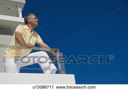 Stock Image - Older couple relaxing at home. Fotosearch