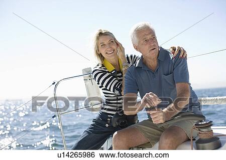 Older couple sitting on boat View Large Photo Image Stock Photograph - Older couple sitting on boat. Fotosearch