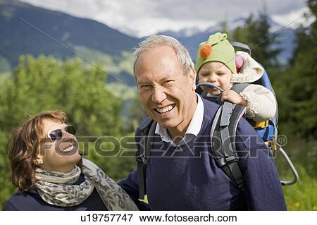 Older couple walking with grandchild View Large Photo Image Stock Photo - Older couple walking with grandchild. Fotosearch