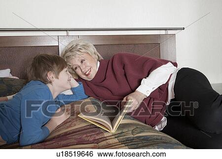 Stock Photograph - Older woman and grandson reading. Fotosearch