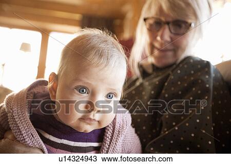 Older woman holding grandchild View Large Photo Image Stock Image - Older woman holding grandchild. Fotosearch