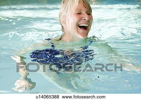 Older woman swimming in pool View Large Photo Image Stock Photo - Older woman swimming in pool. Fotosearch