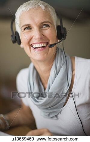 Older woman wearing headset View Large Photo Image Stock Photo - Older woman wearing headset. Fotosearch