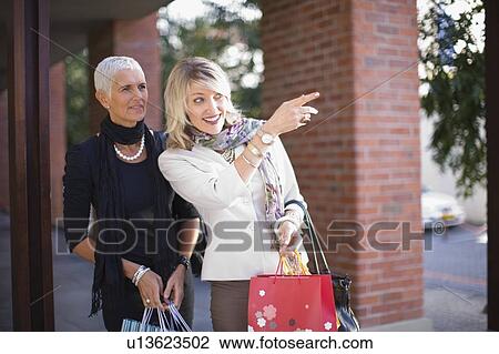 Older women carrying shopping bags View Large Photo Image Stock Image - Older women carrying shopping bags. Fotosearch
