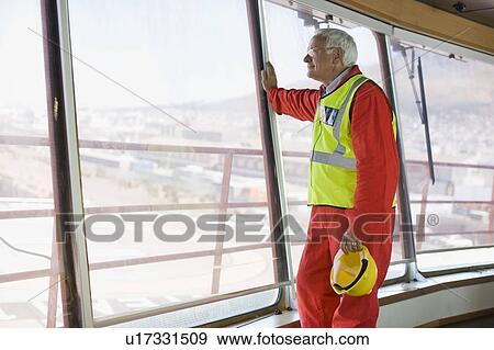 Older worker standing on guardrail View Large Photo Image Stock Photo - Older worker standing on guardrail. Fotosearch