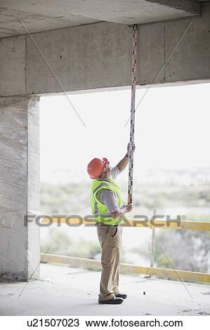 Older worker with levelling board View Large Photo Image Stock Image - Older worker with levelling board. Fotosearch