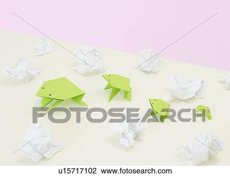 Stock Image - origami frogs amidst scrunched paper. Fotosearch