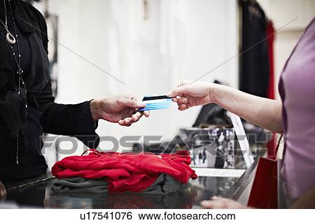 Stock Photograph - Paying with a card. Fotosearch
